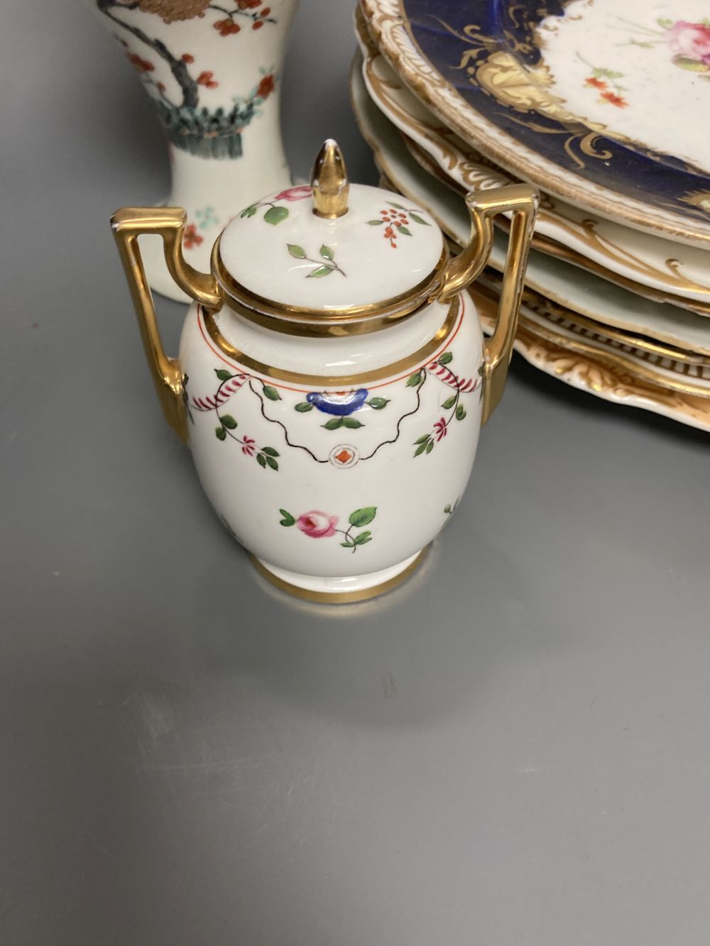 A Worcester Kakiemon vase, c.1765, a 19th century Paris porcelain plate and three tea bowls and 19th century English porcelain plates e